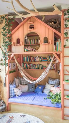 a bed with a hammock hanging from it's side and bookshelves