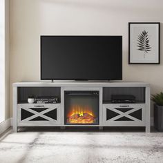 an entertainment center with a fireplace in the middle and a flat screen tv above it