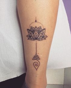 a woman's leg with a tattoo on it and a flower in the center