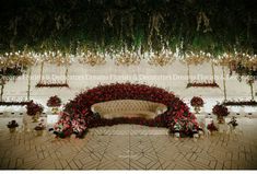 an elaborately decorated stage with flowers and chandeliers