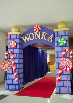 the entrance to wonka is decorated with candy canes and lollipops