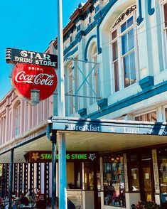 an old building with a coca - cola sign on the corner