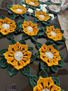 several crocheted flowers sitting on top of a table