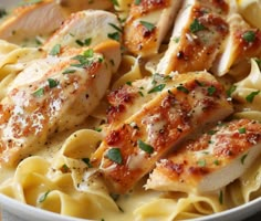 chicken and pasta with parmesan cheese in a white bowl