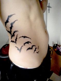 a woman's stomach with bats on it and the bottom part of her belly