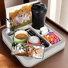 there is a tray that has pictures on it and drinks in the cup next to it