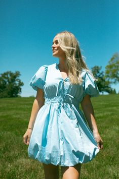 Loving this unique bubble hem dress in the prettiest blue color! It's so feminine and perfect for the spring/summer. Featuring functional bow ties, a v-neckline and a stretchy-elastic waist. Paige wearing the Elle Dress. slight puff sleeve care instructions: hand wash cold, dry flat 100% cotton / lining: 100% polyester true to size Grace is 5'1" wearing a small Bubble Hem Dress, Elle Dress, Bubble Hem, Bow Dress, Hem Dress, Dress Romper, Bow Ties, Dress With Bow, Puff Sleeve