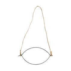 a brown cord hanging from the side of a white wall with an oval shaped object on it