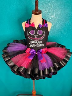 a tutu dress made to look like a cat with purple and pink trims