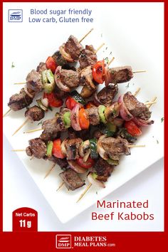 the book cover for marinated beef kabobs is shown on a white plate