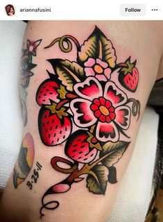 a woman's thigh with flowers and strawberries on it