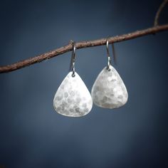 A smaller variation of my Grounded Earrings, these earrings remind me of the stability, power, and groundedness of boulders. Wear them to feel confident, grounded, and strong in your skin. Hammered on the backside to produce a unique soft white shimmer on the front, they are light weight and catch the sun beautifully. Earrings are approximately .75 inches long and with the ear wire hang approximately 1.25 inches long. Earrings are fine silver (.999) and hang from sterling silver ear wires. Free Silver Snake Chain, Triangle Earrings, Healing Jewelry, Rolo Chain, Hammered Silver, Soft White, Ear Wire, Snake Chain, Jewelry Handmade