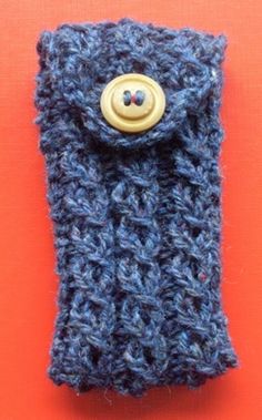 a blue crocheted cell phone case with a button on the front and side