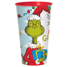 the grinch is holding a christmas present in his hand and wearing a santa hat