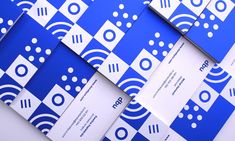 blue and white brochures are stacked on top of each other in an abstract pattern