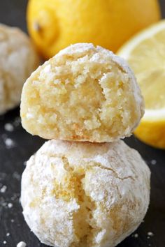 three lemon cookies stacked on top of each other with two lemons in the background