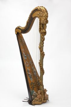 an ornately decorated harp on display against a white background