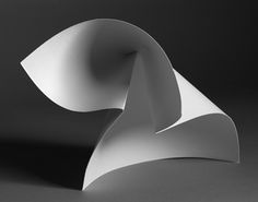 an abstract white sculpture is shown against a black background with light coming through the top