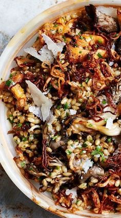 a white bowl filled with food on top of a table