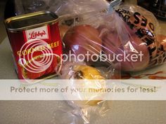 an assortment of food wrapped in plastic on a table