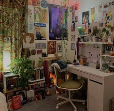 a room with lots of clutter on the walls and desk in front of it