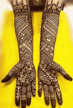 two hands with henna designs on them