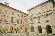 an old stone building with arches and doorways