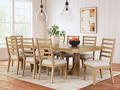 a dining room table with six chairs and a bowl of fruit