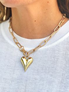 a golden plump heart pendant necklace with a large gold chain link Gold Chunky Chain Necklace For Valentine's Day, Gold Open Heart Necklace With Lobster Clasp, Valentine's Day Heart Pendant Paperclip Chain Jewelry, Trendy Heart-shaped Chain Necklace With Lobster Clasp, Gold Heart Necklace With Chunky Chain For Gift, Gold Heart Necklace With Chunky Chain, Everyday Chunky Chain Heart Pendant Necklace, Everyday Heart Charm Paperclip Necklace, Valentine's Day Paperclip Chain Necklace