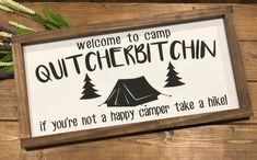 a sign that says, welcome to camp outcropin if you're not a happy camper take a hike