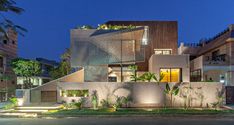 a modern house is lit up at night