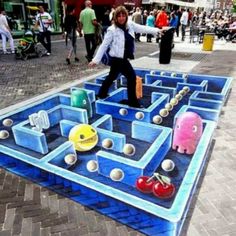 a woman standing on top of a blue maze in the shape of an elephant and pig