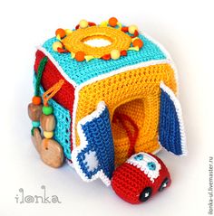 a crocheted toy with a car in it