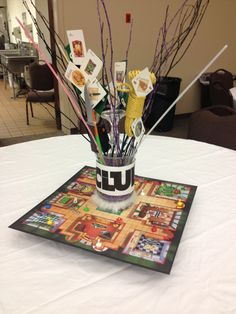 a vase filled with lots of stickers on top of a white tablecloth covered table