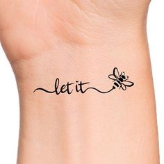 a woman's wrist with a tattoo that says let it fly