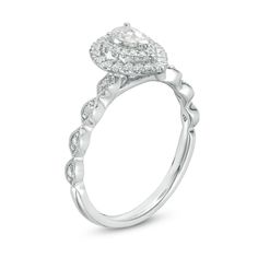 a white gold engagement ring with a pear shaped diamond center