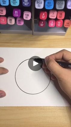 a person is using a marker to draw a circle in front of a calculator