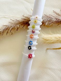 a white piece of cloth with beads and flowers on it