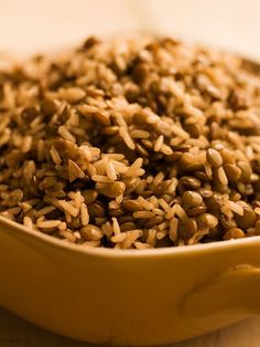 brown rice in a yellow bowl on a table