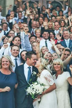 a group of people that are standing in front of each other with their hands up