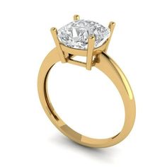 a yellow gold engagement ring with a round cut diamond in the center, on a white background