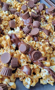 chocolate covered popcorn with marshmallows and other toppings on a baking sheet