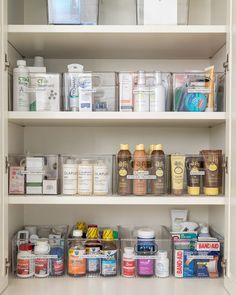 the shelves are filled with many different types of medicine and other medical supplies in plastic containers