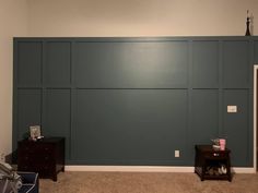 an empty room with green paneling on the wall