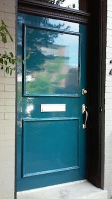 a blue door with a sign on it