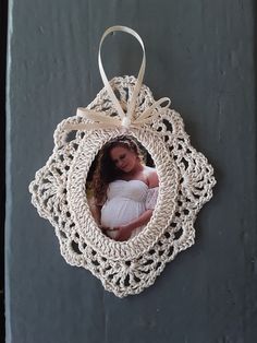 an ornament hanging on the side of a wall with a baby in it