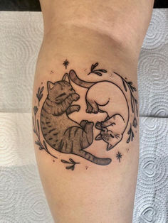 a cat and mouse tattoo on the leg