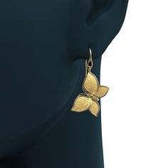 Experience Italian craftsmanship at its finest with our exquisite gold dangle drop earrings. The centerpiece of these earrings is a delicate butterfly with elegantly crafted leaves as its wings, creating a captivating and nature-inspired design. Available in both 14k and 18k gold, these earrings bring a touch of luxury and nature's beauty to your style. Elevate your look with the perfect blend of Italian artistry and organic elegance, shop now to adorn yourself with this unique masterpiece. 14k Italian Engagement Ring, Italian Gold Jewelry, Delicate Butterfly, Leaf Texture, Gold Dangle Earrings, Italian Craftsmanship, Italian Jewelry, Nature Inspired Design, Gold Butterfly