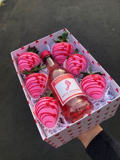 a box filled with chocolate covered strawberries and a bottle of wine