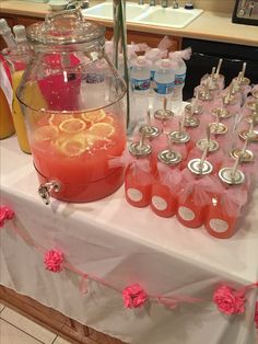 a table topped with lots of bottles filled with liquid and orange slices next to each other